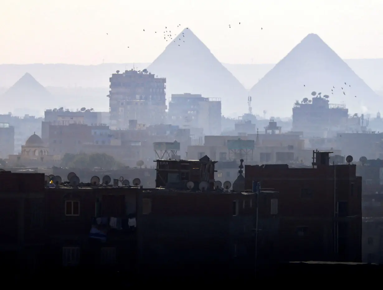 FILE PHOTO: A general view of fog over the Great Pyramids and old houses in Cairo