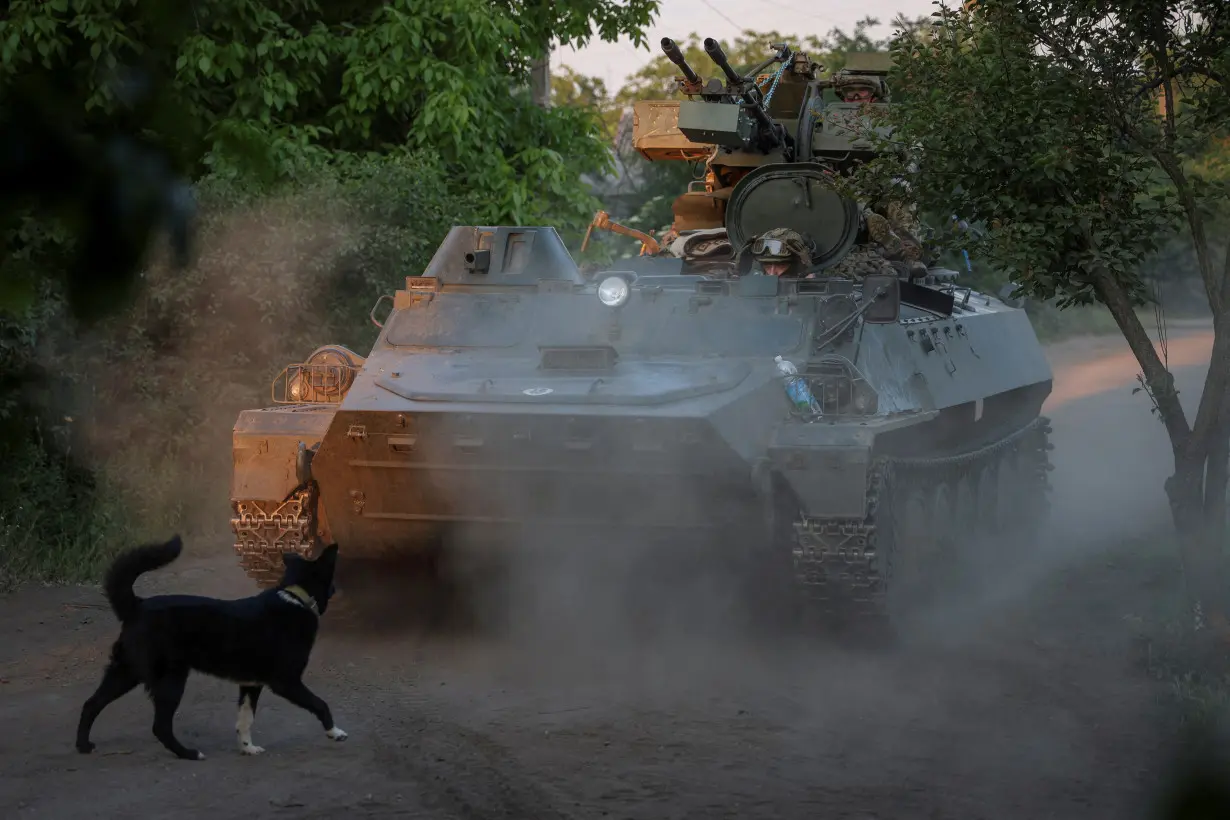 FILE PHOTO: A Ukrainian serviceman rides an APC at a frontline near the town of Bakhmut