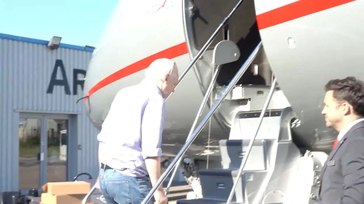 WikiLeaks founder Julian Assange boards a plane at a location given as London