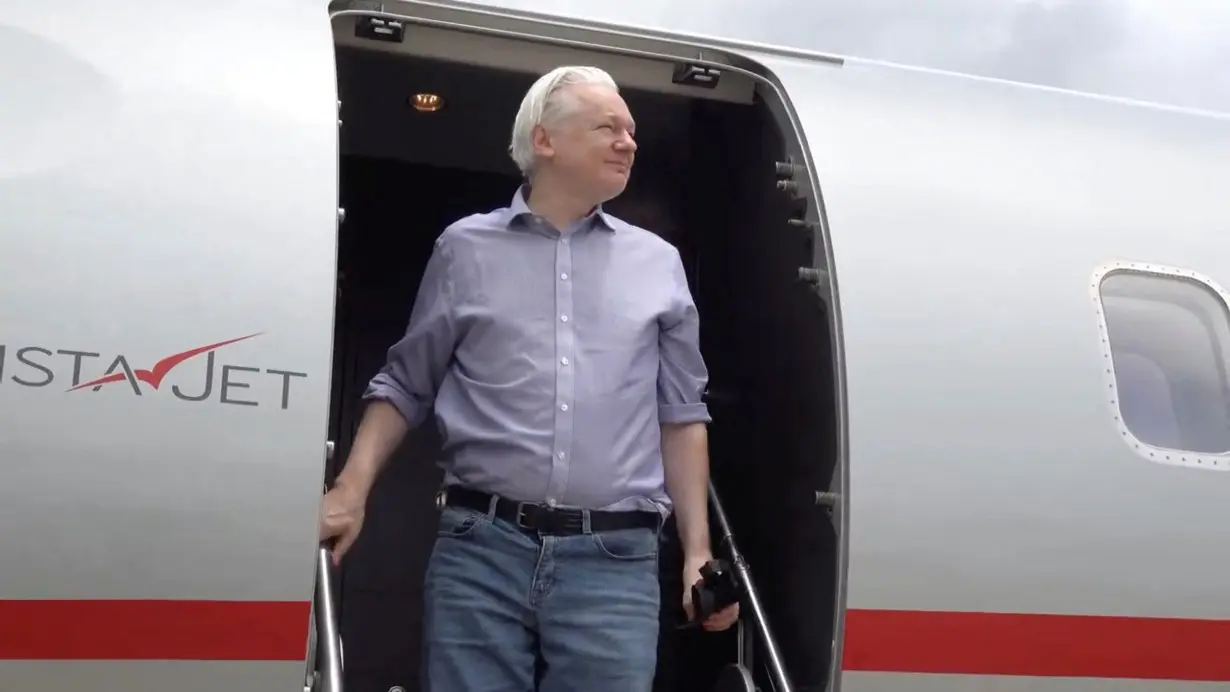 WikiLeaks founder Julian Assange disembarks from a plane at Bangkok Don Mueang International Airport