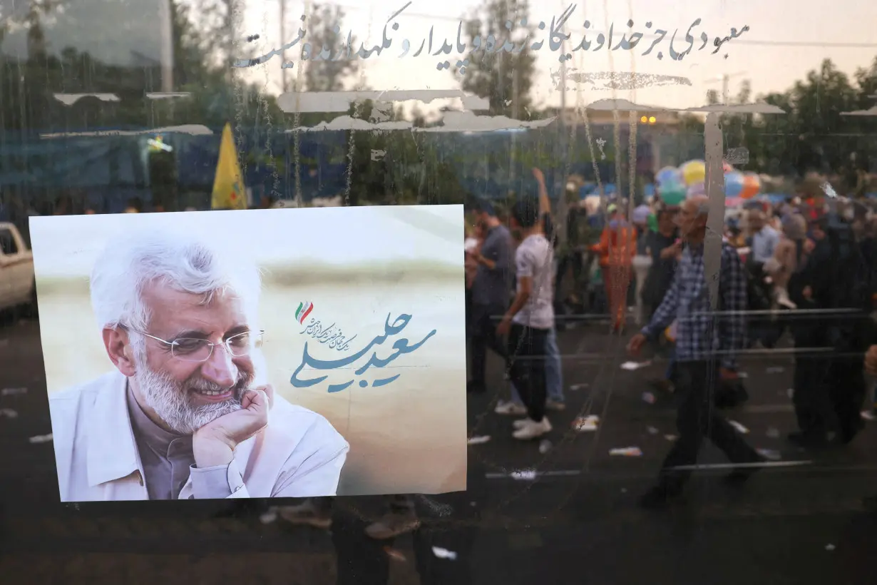 FILE PHOTO: A poster of Iranian presidential candidate Saeed Jalili is seen on a street in Tehran
