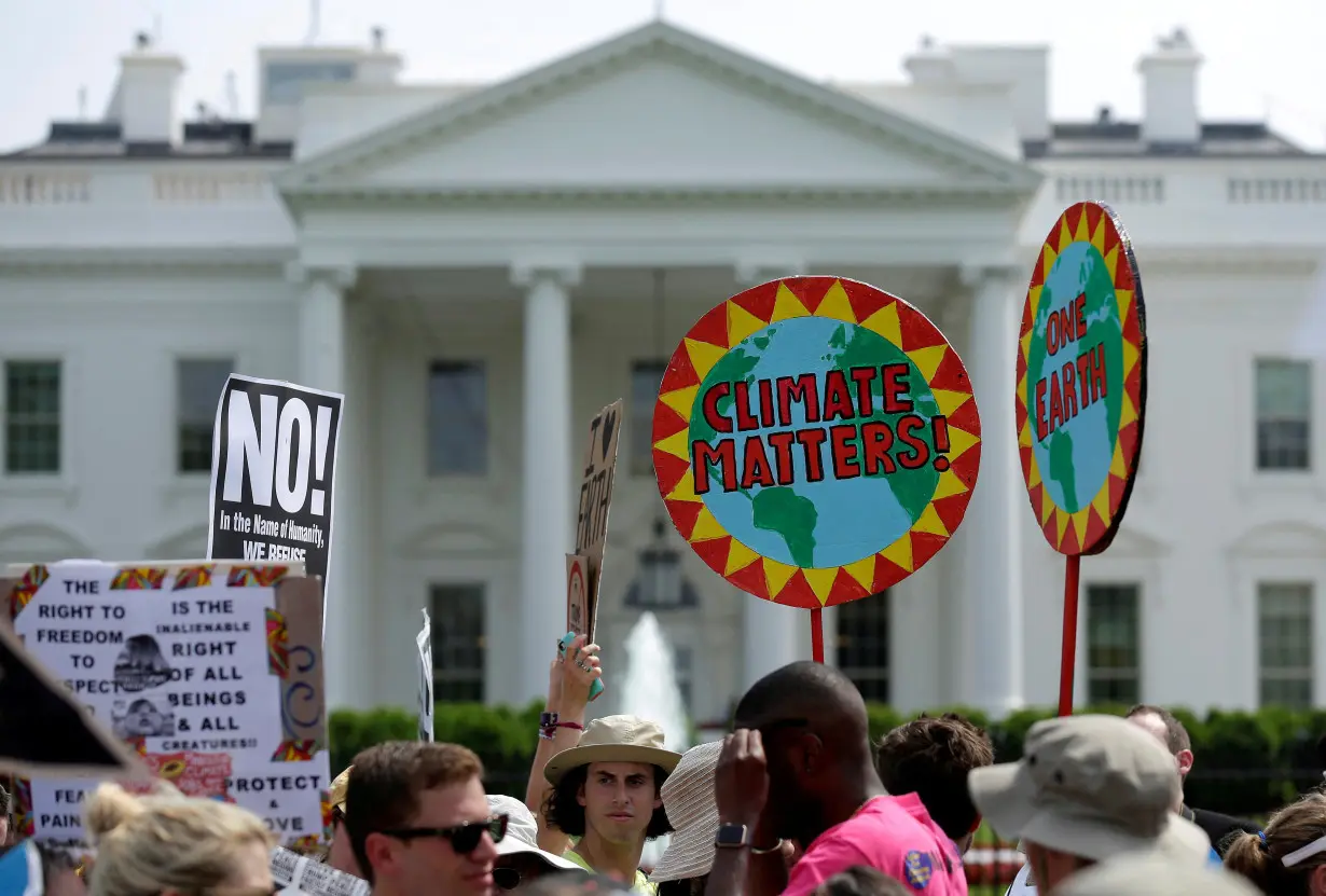 FILE PHOTO: Protesters carry signs during the Peoples Climate March at the White House in Washington