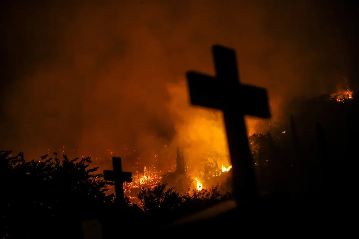 Wildifre burns in the village of Latas in southern Greece