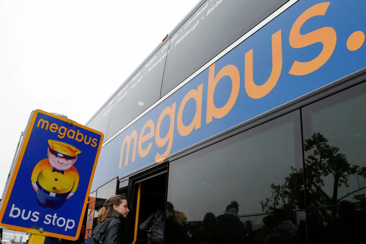 FILE PHOTO: Passengers board a Megabus bus in New York City