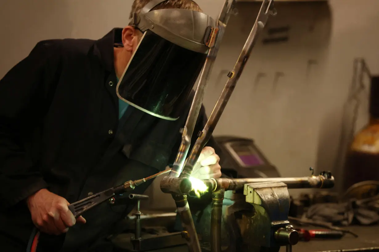 A worker assembles a new bike frame at the Pashley bicycle factory in Stratford-upon-Avon