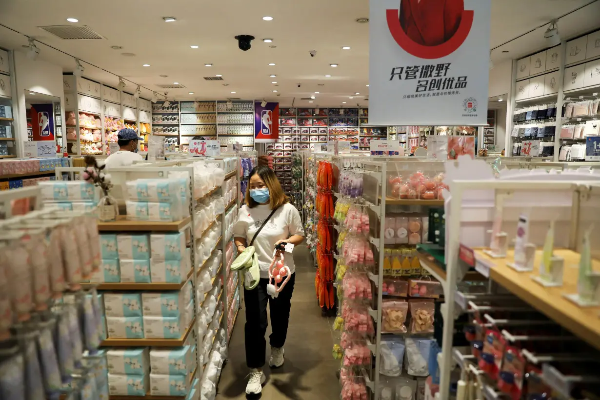 FILE PHOTO: Customer shops at a store of Chinese retailer MINISO Group in Beijing