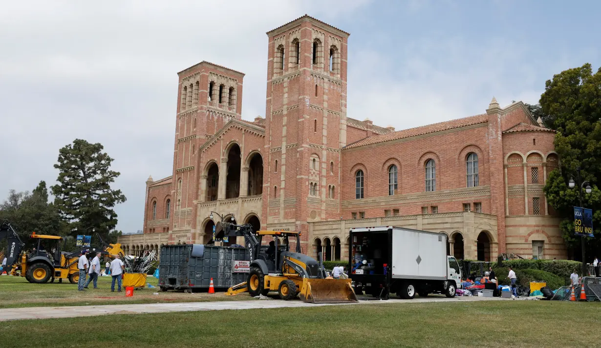 Workers remove the remnants of a protest encampment at University of California Los Angeles