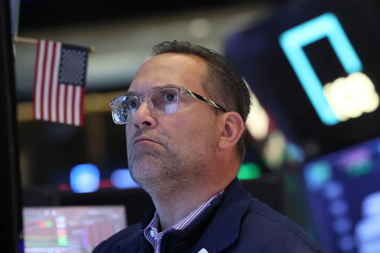 Traders work on the floor of the NYSE in New York