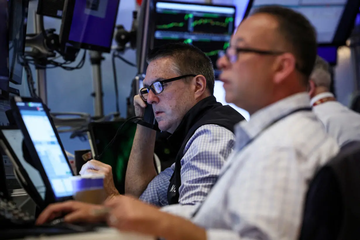 Traders work on the floor of the NYSE in New York