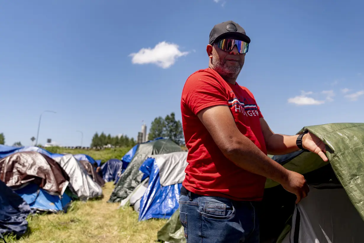 Hundreds of asylum-seekers are camped out near Seattle. There's a vacant motel next door