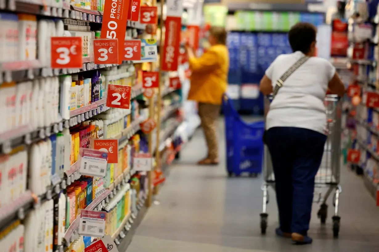 Customers shop in a supermarket near Paris