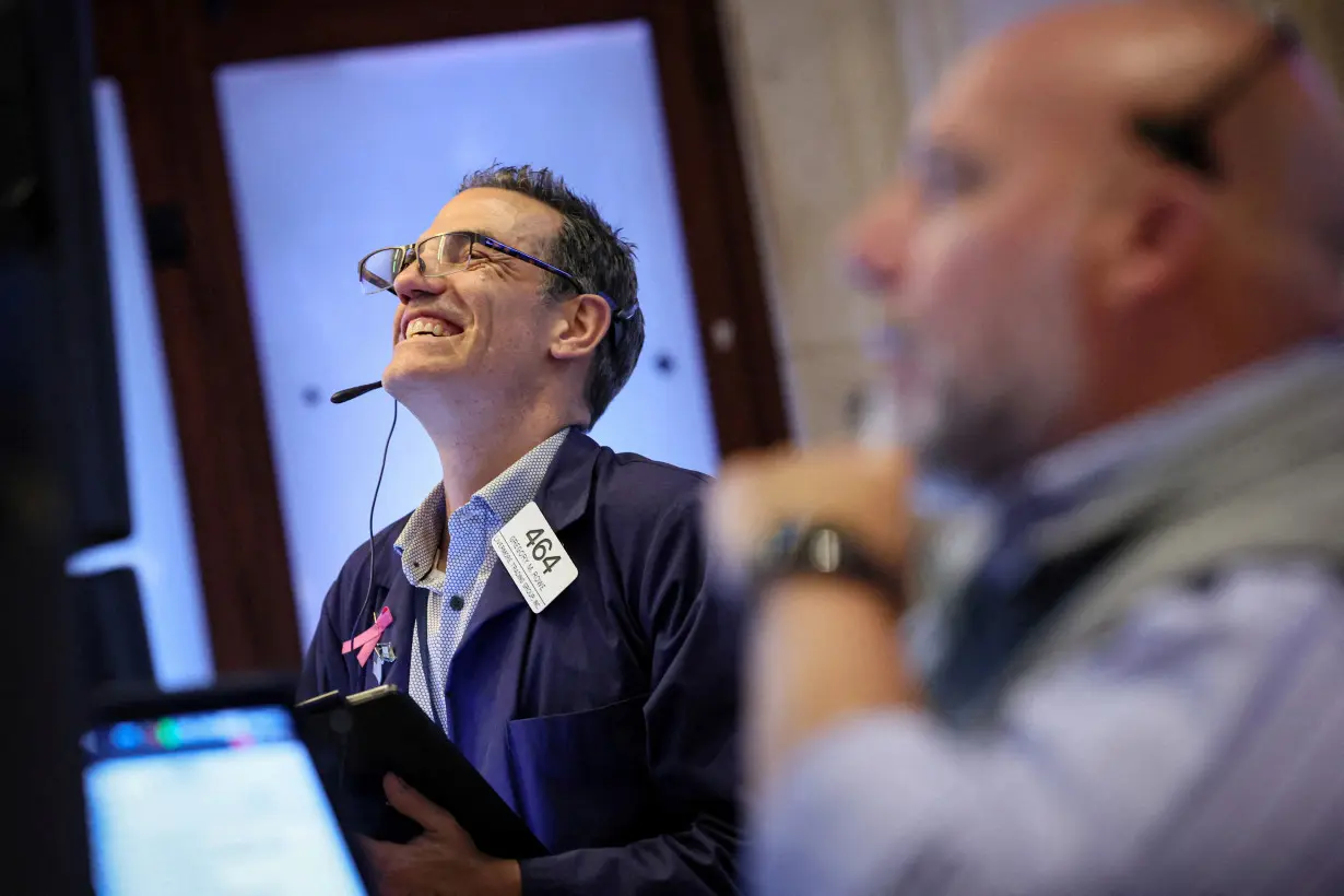 FILE PHOTO: Traders work on the floor of the NYSE in New York