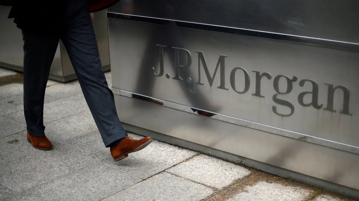 FILE PHOTO: A man walks into the JP Morgan headquarters at Canary Wharf in London