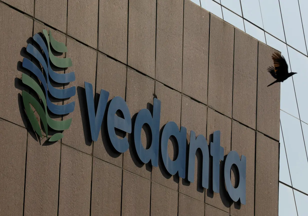 FILE PHOTO: A bird flies past the logo of Vedanta installed on the facade of its headquarters in Mumbai