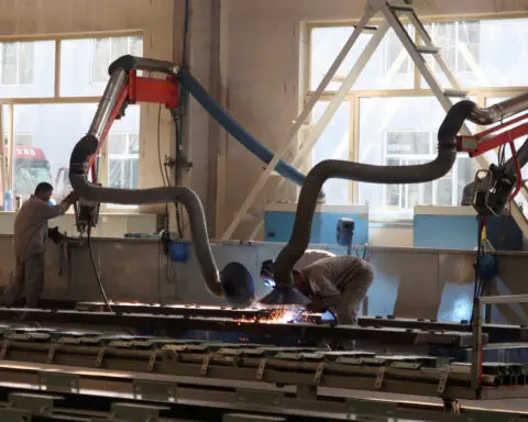 China's manufacturing surges, Caixin PMI shows, but global risks grow