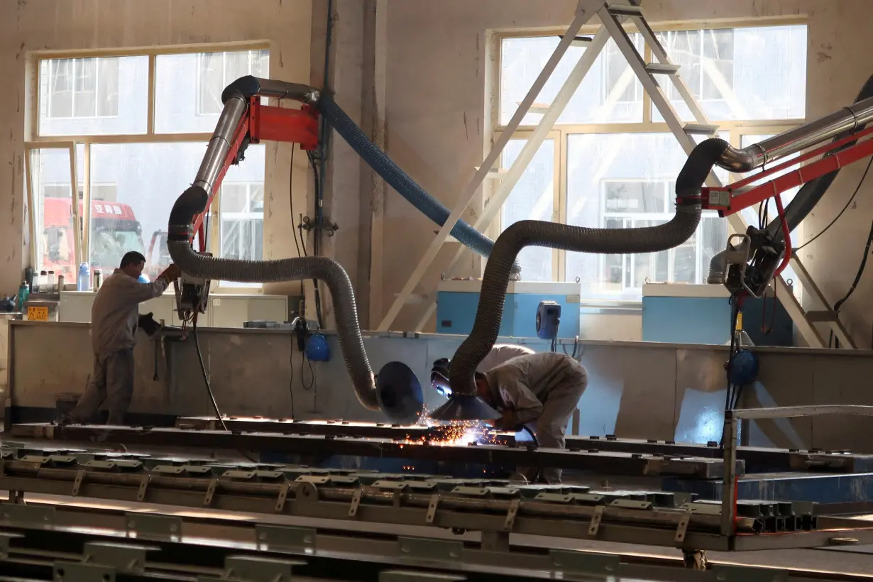 FILE PHOTO: Employees work at Jingjin filter press factory in Dezhou