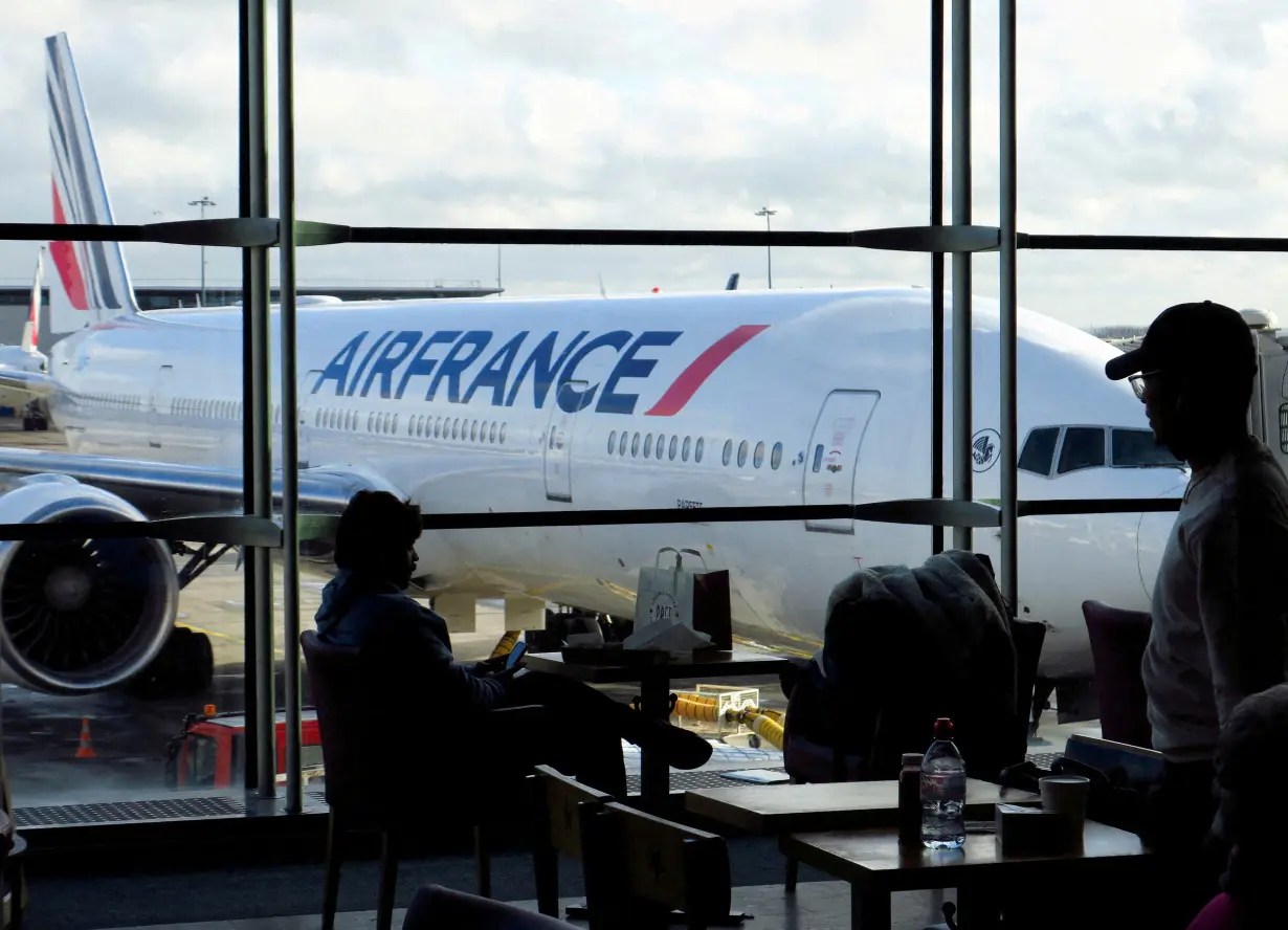 FILE PHOTO: Passengers wait for an Air-France flight inside the Terminal 2 at Paris Charles de Gaulle airport in Roissy-en-France near Paris