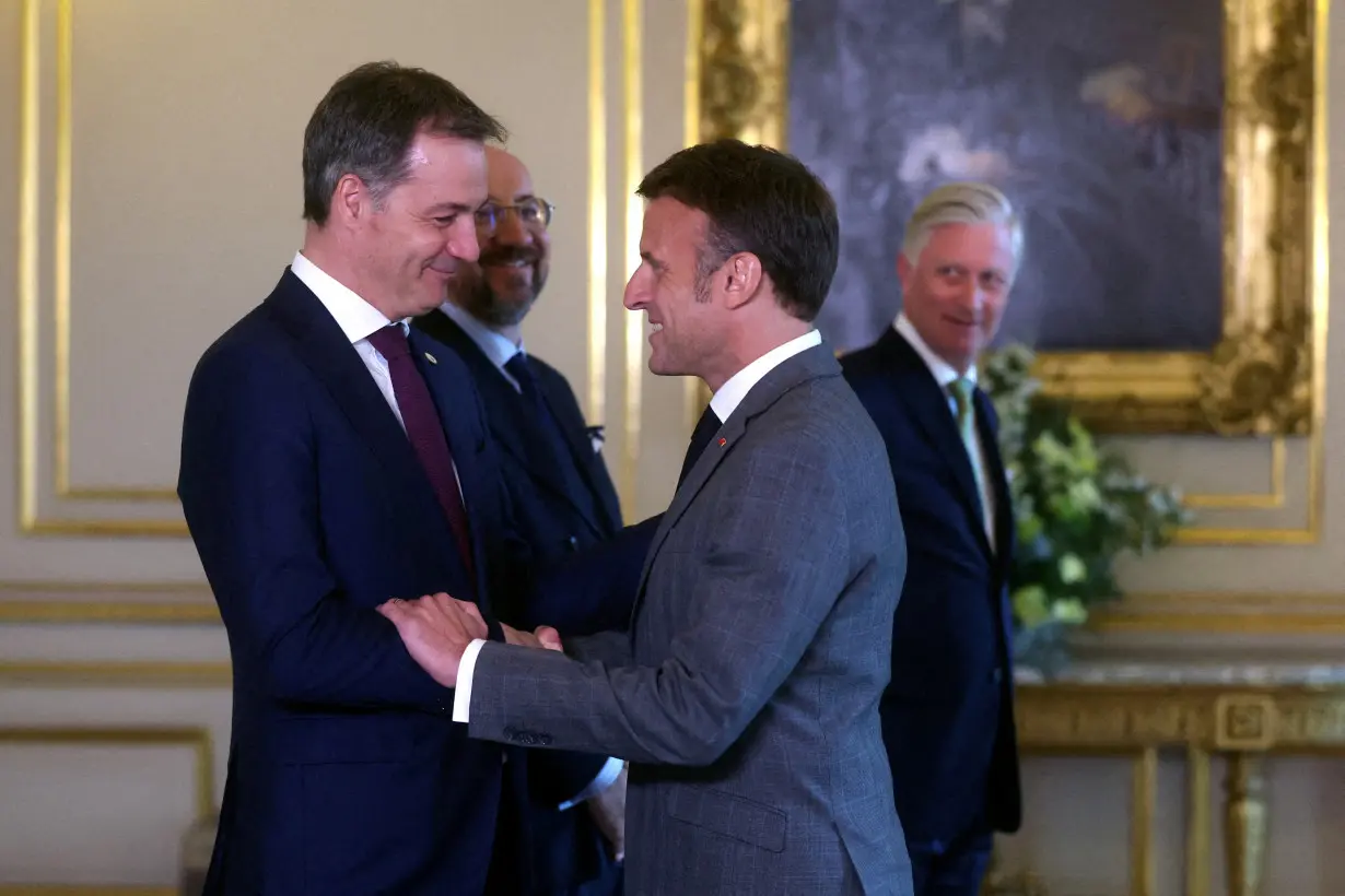 French President Emmanuel Macron is welcomed by Belgian Prime Minister Alexander De Croo