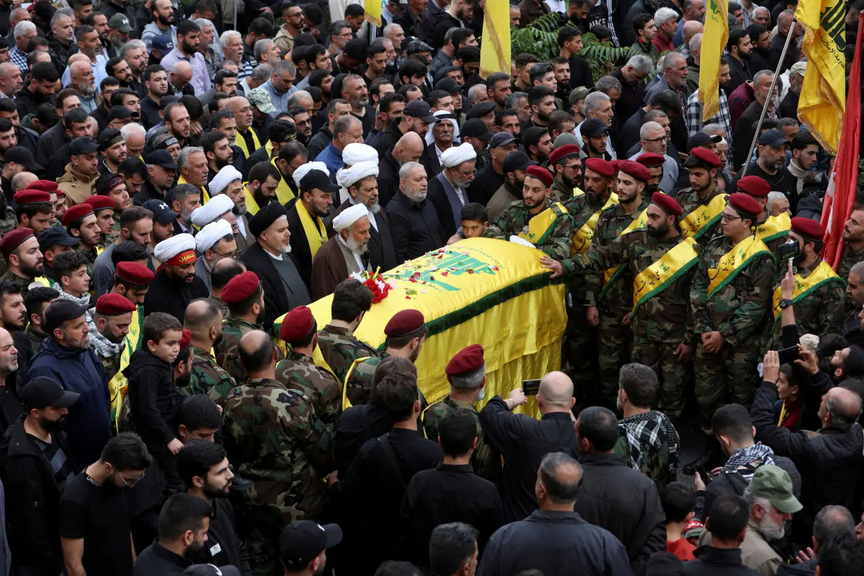 FILE PHOTO: Mourners gather near the coffin of Hezbollah member Jaafar Serhan, who was killed while deployed in Syria with Hezbollah, during his funeral in Mashghara