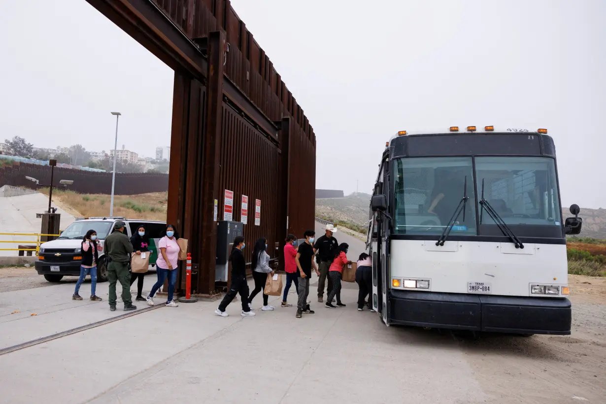 FILE PHOTO: Asylum-seekers at border walls between the U.S. and Mexico