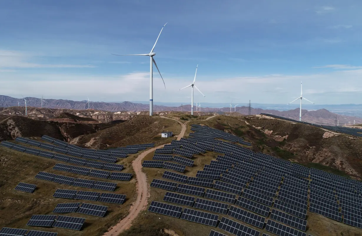 Wind turbines and solar panels are seen at a wind and solar power plant in Zhangjiakou