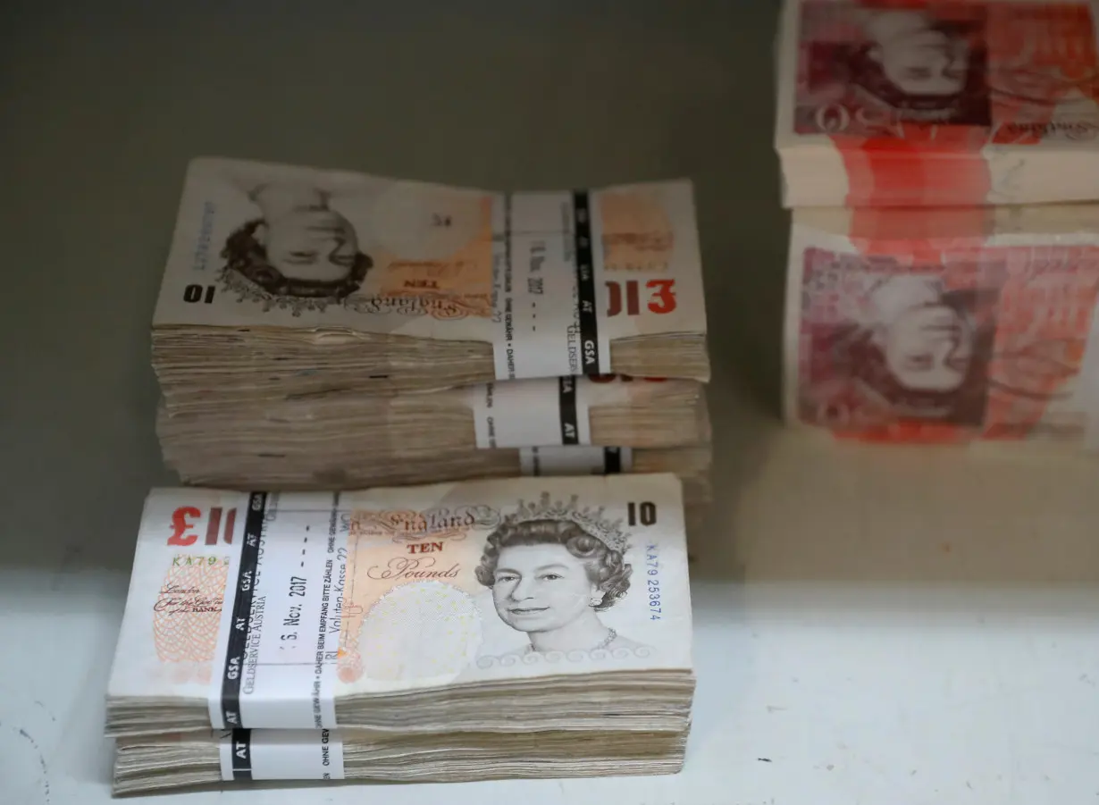 FILE PHOTO: Wads of British Pound Sterling banknotes are stacked in piles at the Money Service Austria company's headquarters in Vienna