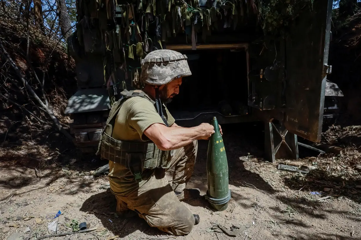 FILE PHOTO: Ukrainian serviceman prepares a shell for an M109L self-propelled howitzer before firing towards Russian troops near a front line, in Donetsk region