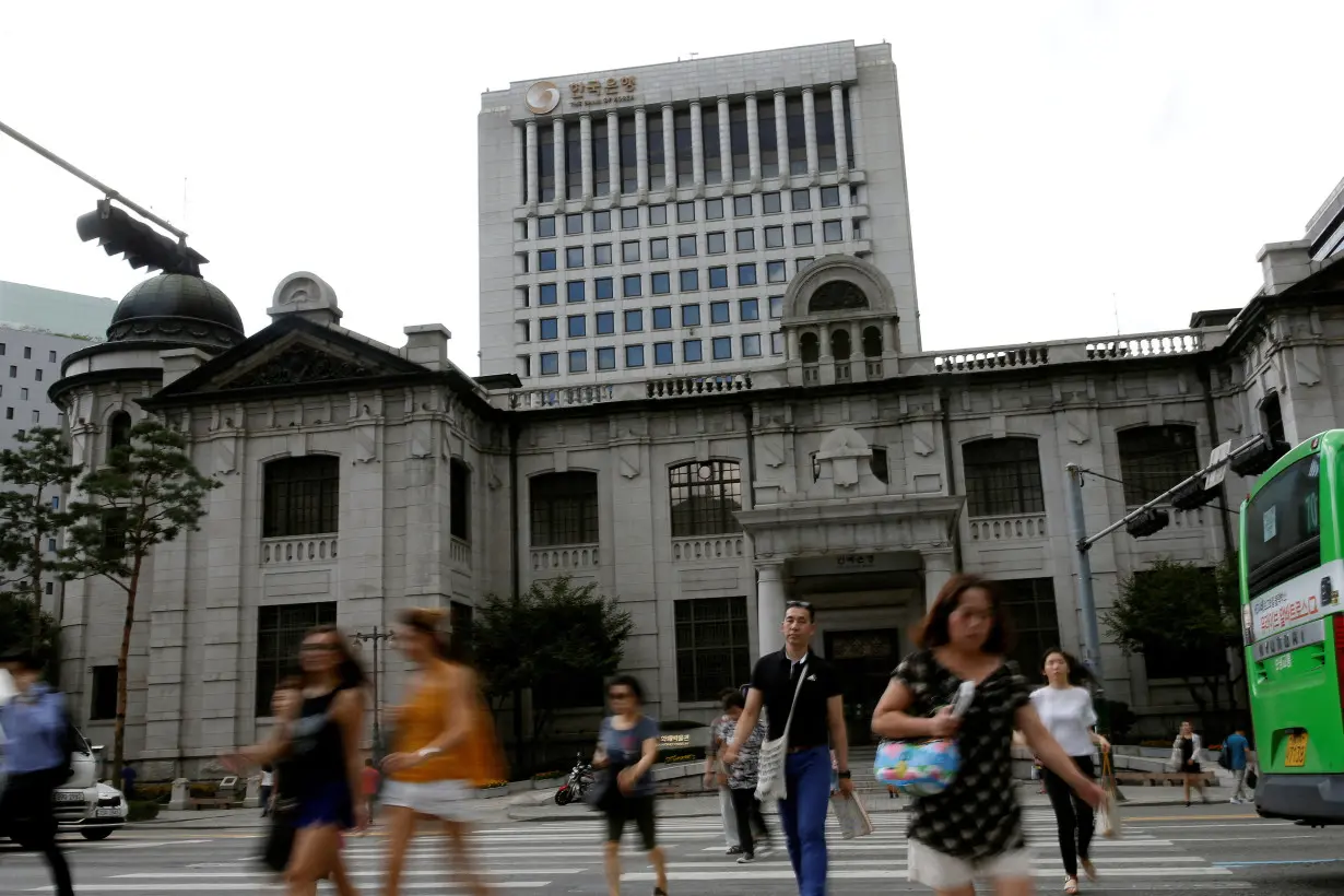 FILE PHOTO: People walk on a zebra crossing in front of the buliding of Bank of Korea in Seoul