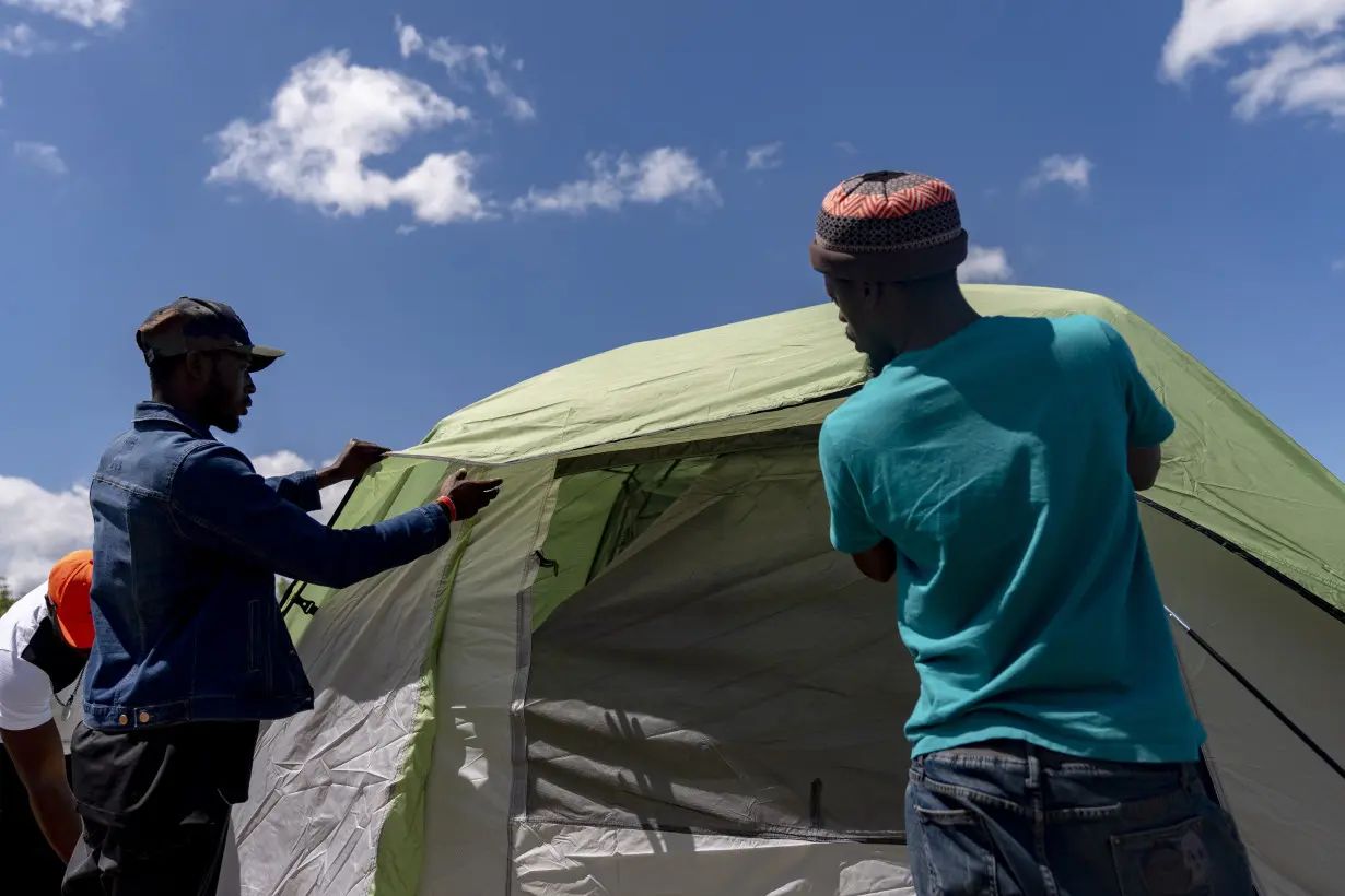 Hundreds of asylum-seekers are camped out near Seattle. There's a vacant motel next door