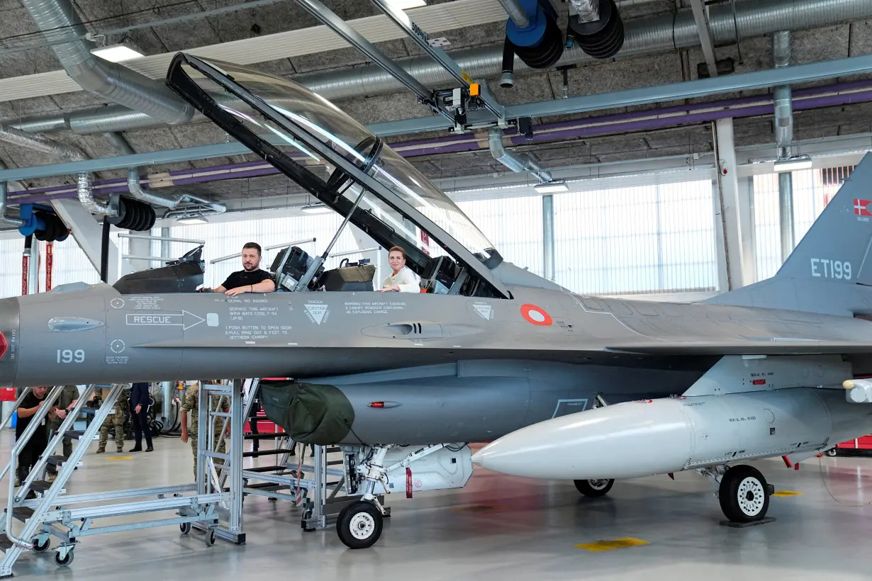 FILE PHOTO: Ukrainian President Volodymyr Zelenskiy and Danish Prime Minister Mette Frederiksen sit in an F-16 fighter jet at Skrydstrup Air Base in Vojens