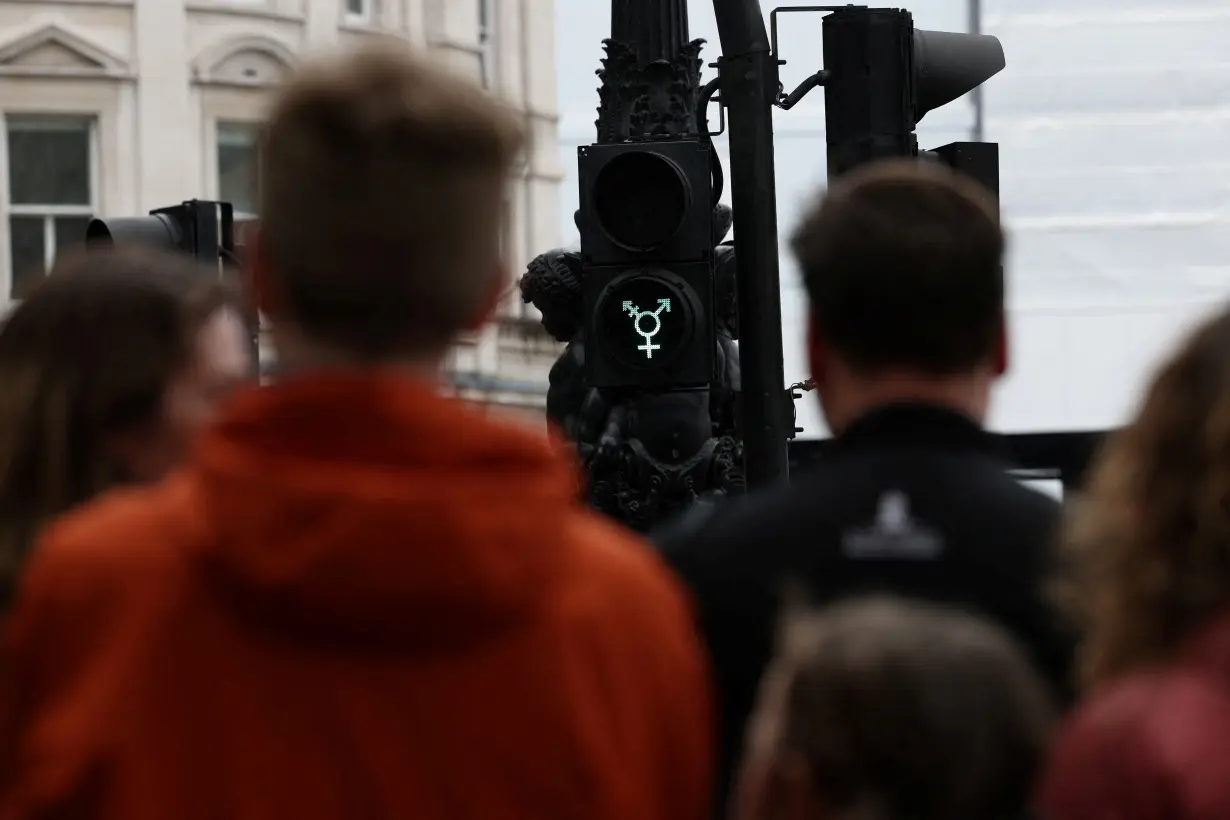 A transgender symbol is displayed on a traffic light in London