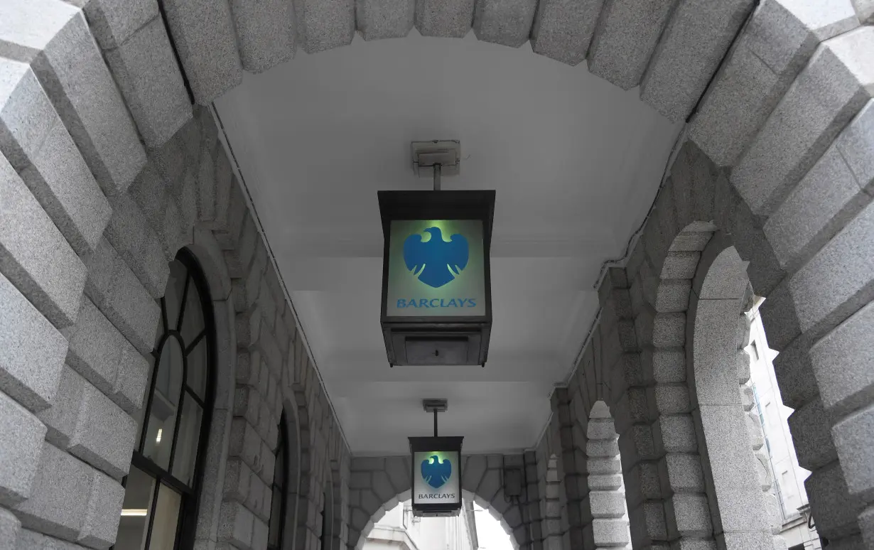 FILE PHOTO: The logo of Barclays bank is seen on glass lamps outside of a branch of the bank in the City of London financial district in London