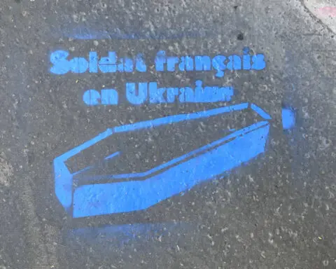 Graffiti with images and messages referencing Ukraine appear on Paris buildings near Parliament