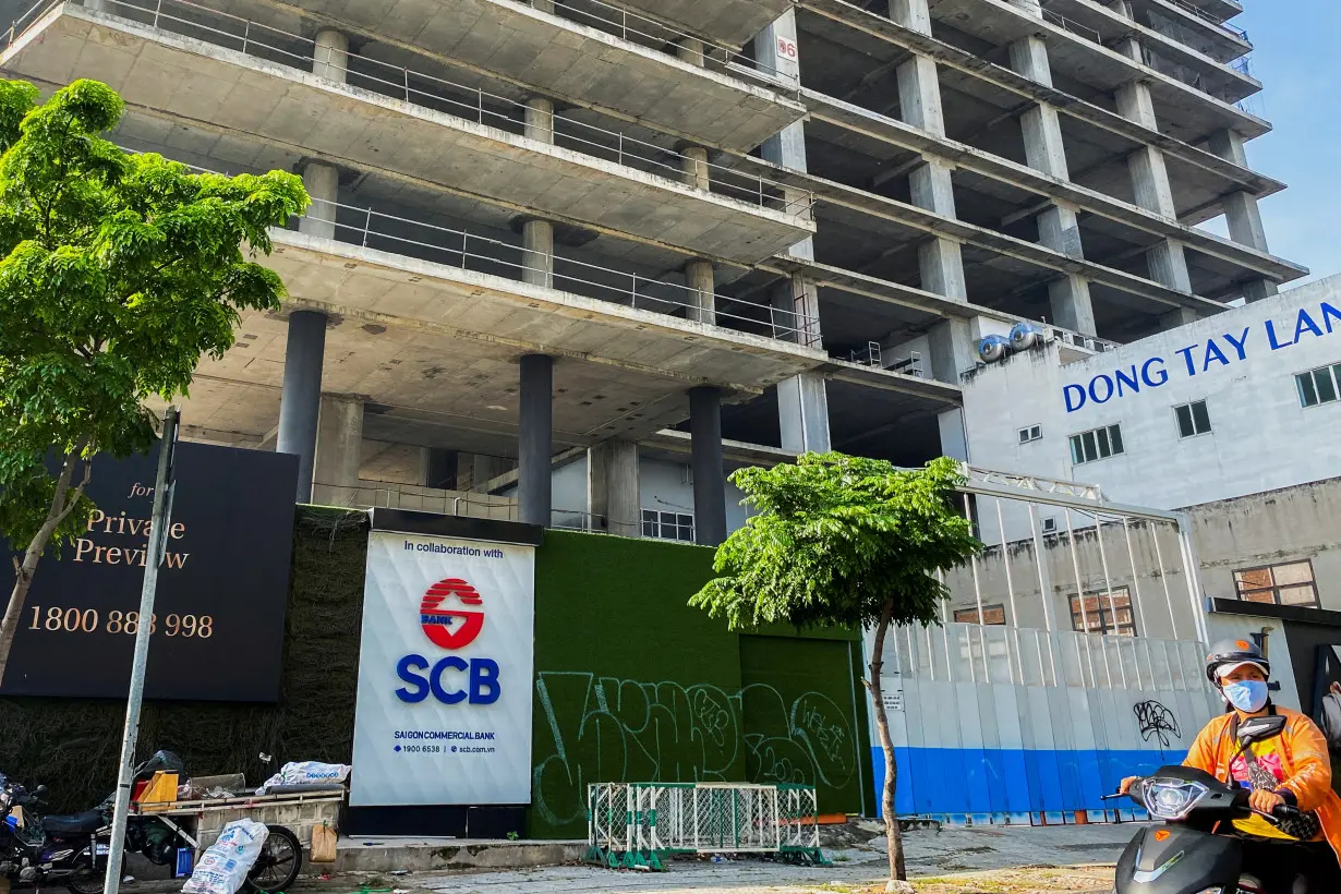 FILE PHOTO: A logo of Saigon Joint Stock Commercial Bank (SCB) is seen in front of an under-construction building in Ho Chi Minh City