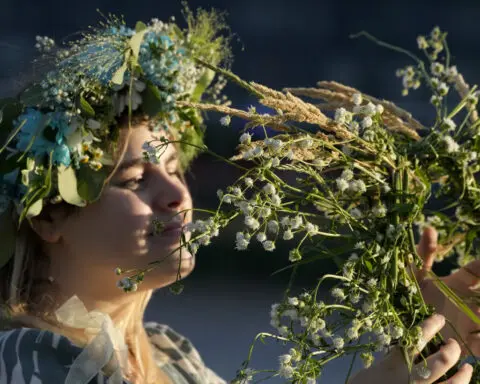 Ukrainians in Warsaw jump over a bonfire, float braids to celebrate solstice custom away from home