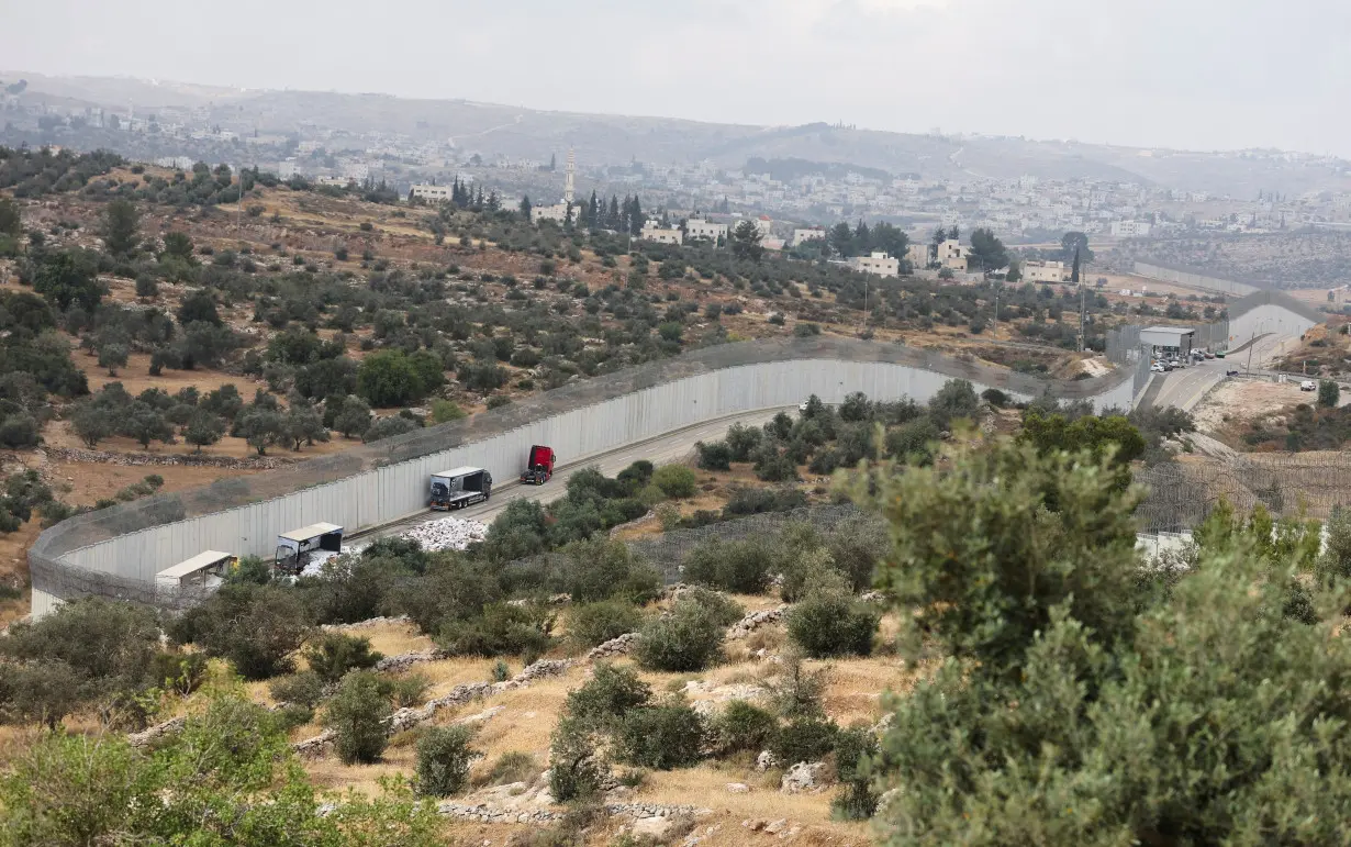 Trucks carrying aid to Gaza stand damaged at checkpoint near Hebron