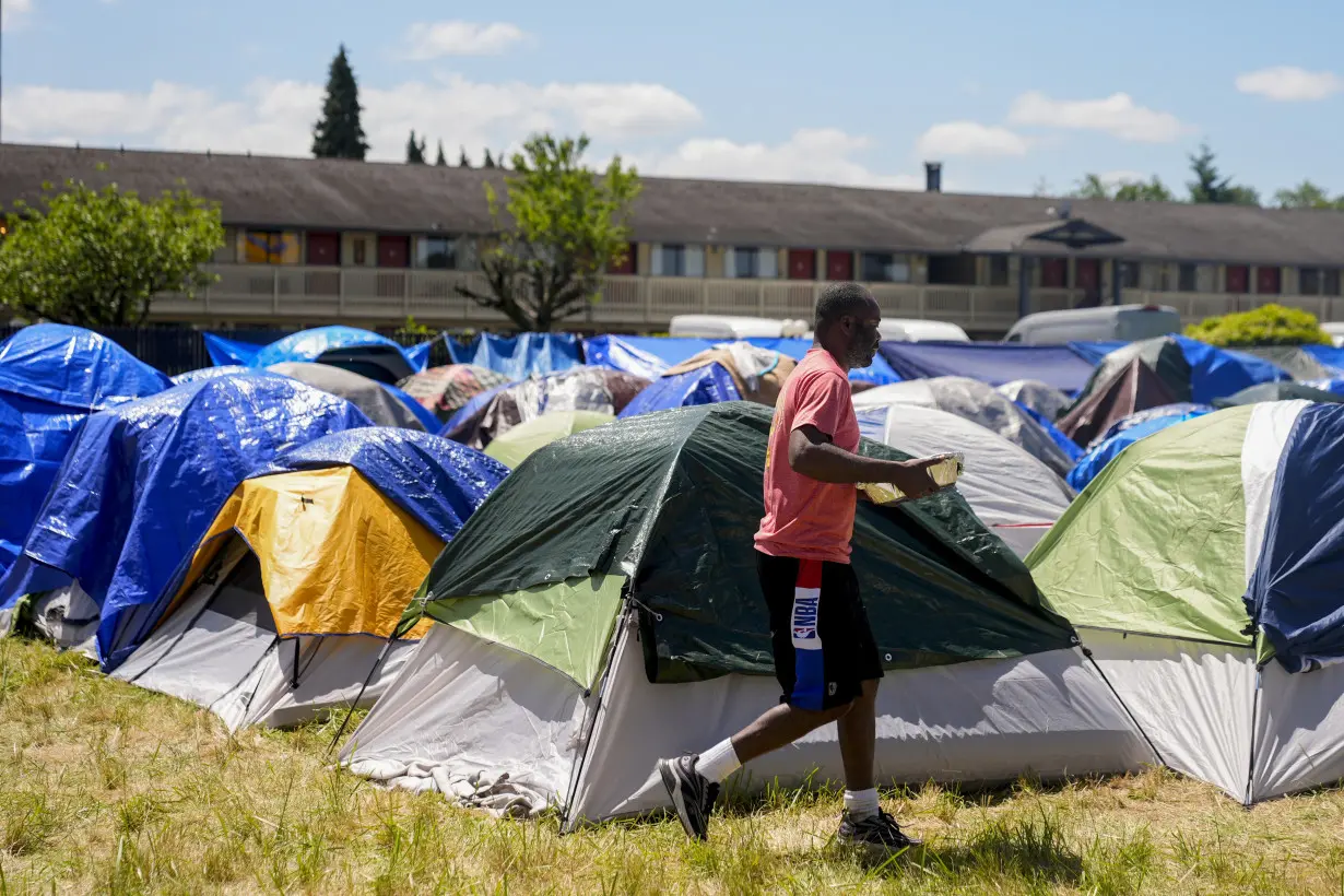 Hundreds of asylum-seekers are camped out near Seattle. There's a vacant motel next door