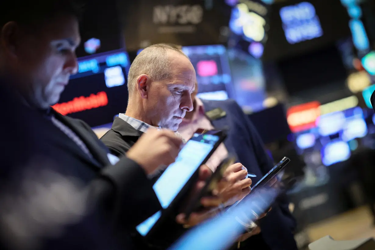 Traders work on the floor of the NYSE in New York