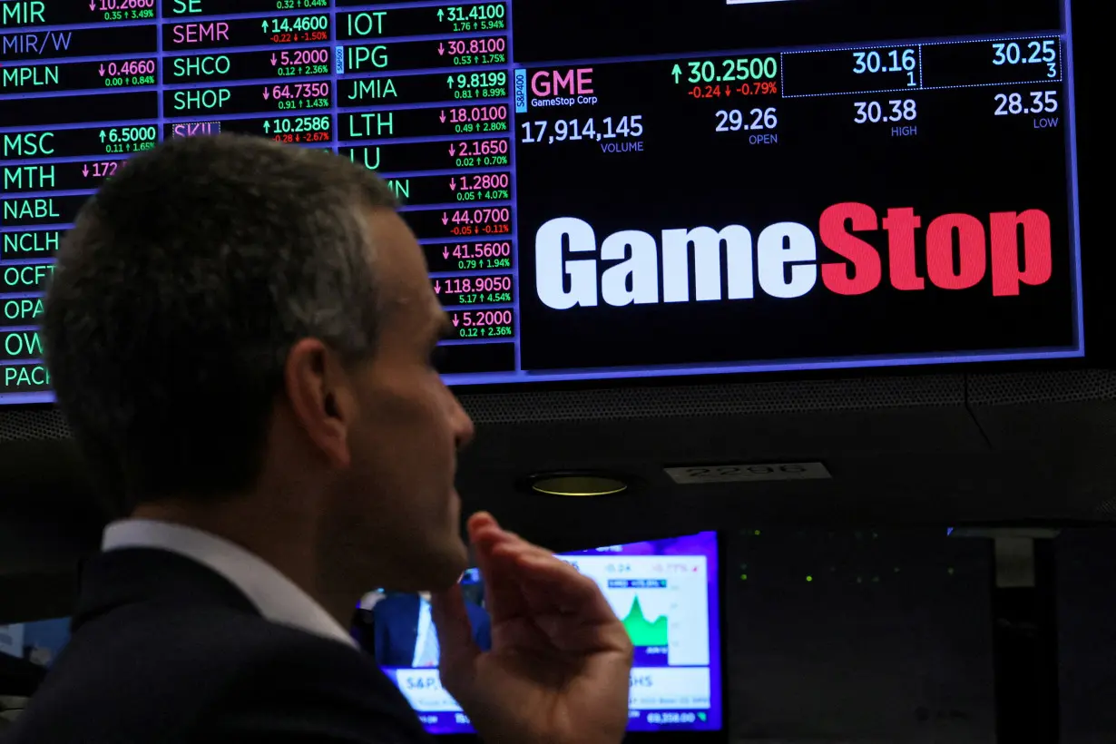 FILE PHOTO: Traders work on the floor of the NYSE in New York