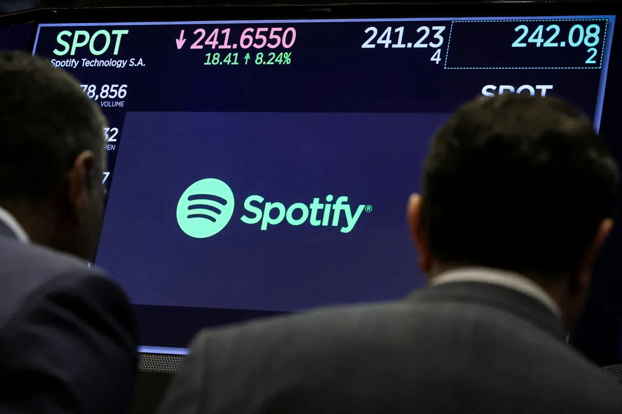 FILE PHOTO: A screen displays the logo and trading information for Spotify on the floor of the NYSE in New York