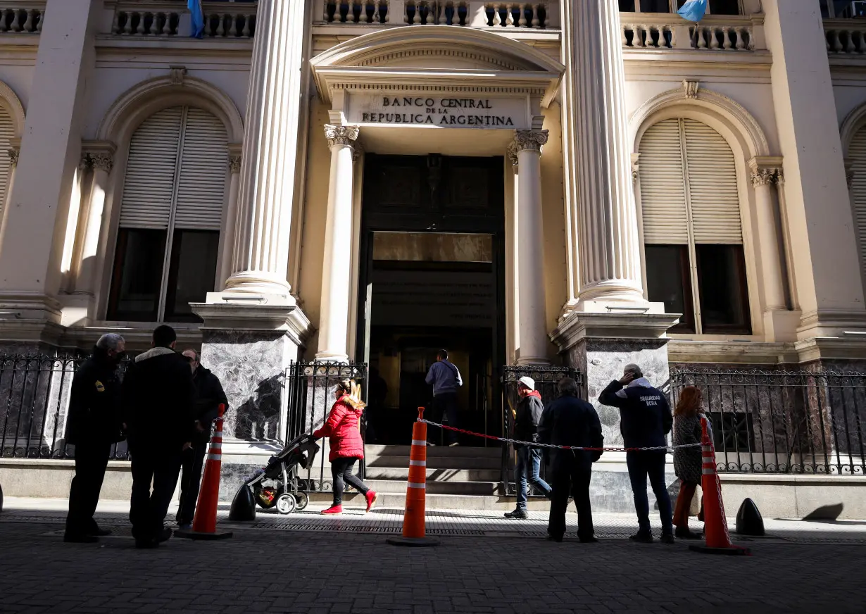 People walk outside Argentina's Central Bank, in Buenos Aires