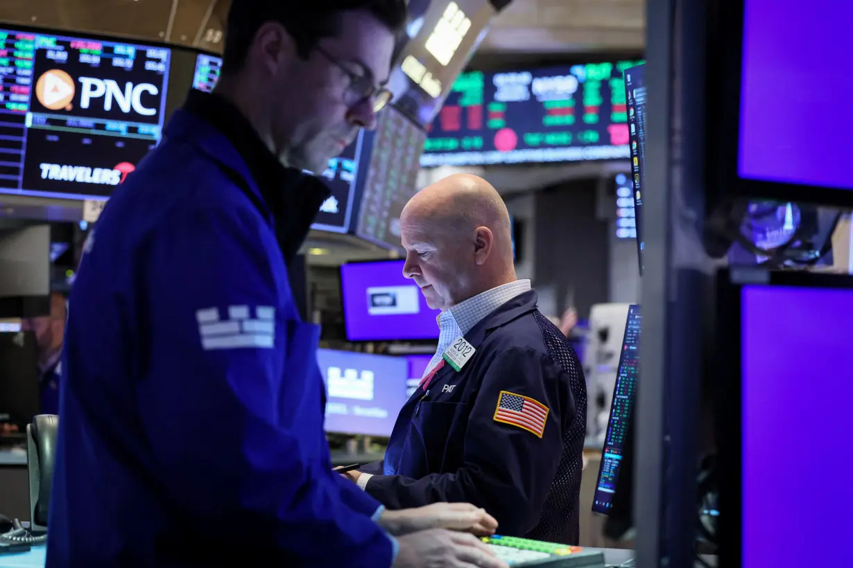 Traders work on the floor of the NYSE in New York