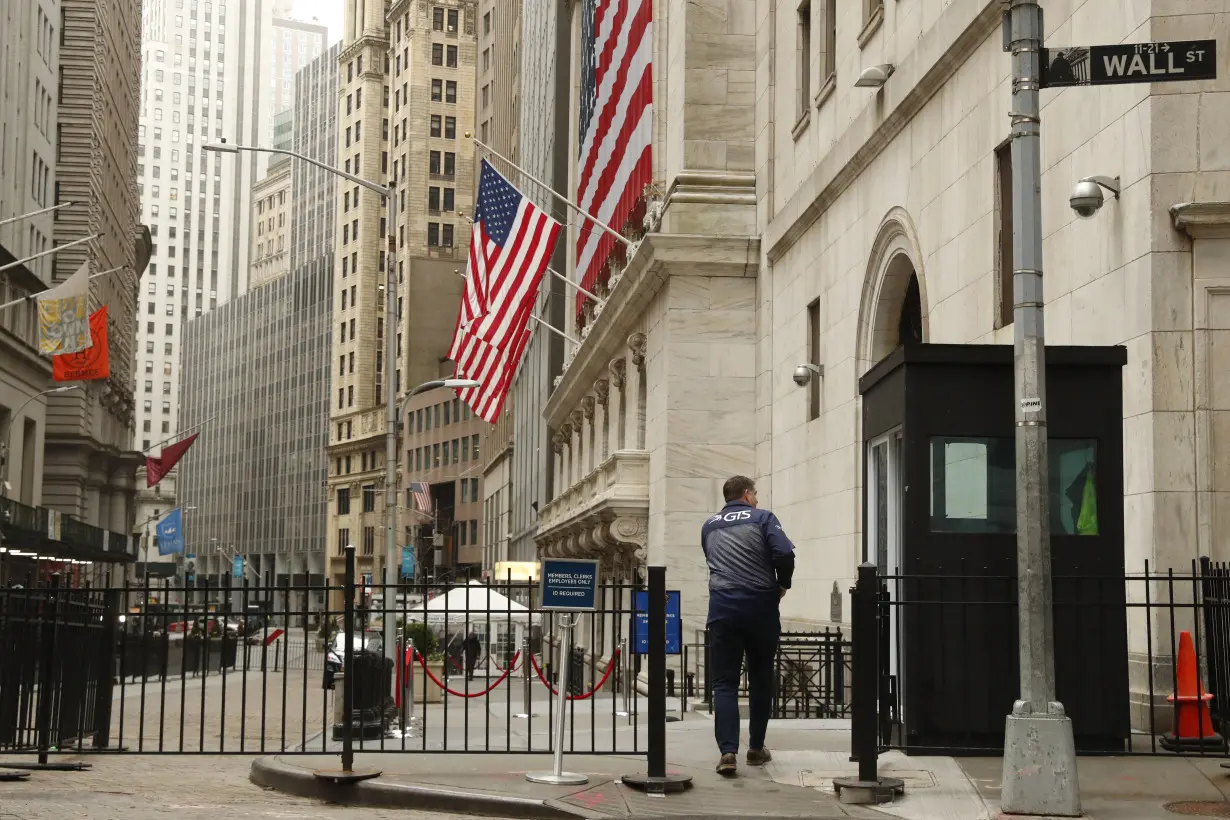 A trader arrives at the NYSE on Wall St. in New York