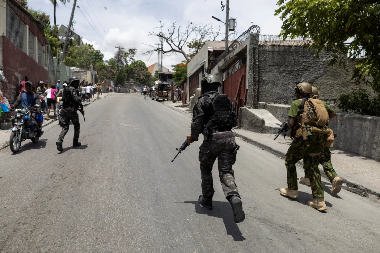 Kenyan police and Haitian National police SWAT units patrol streets in armoured vehicles, in Port-au-Prince