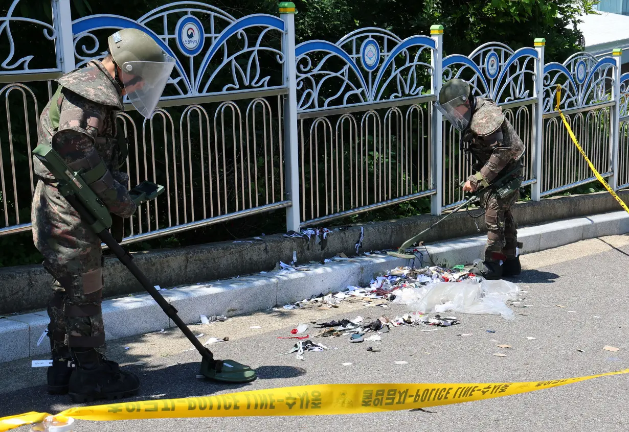 South Korean soldiers examine various objects including what appeared to be trash from a balloon believed to have been sent by North Korea, in Incheon