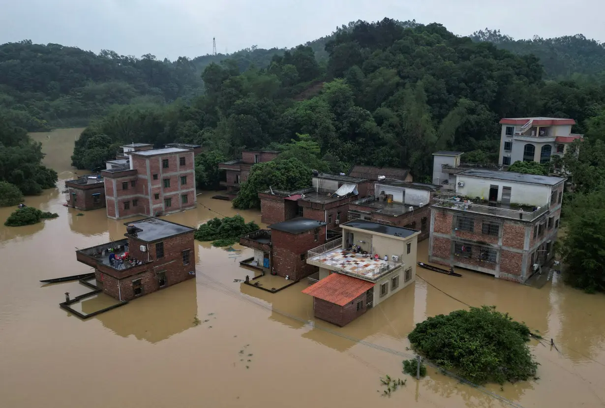 FILE PHOTO: Drone view shows houses submerged in floodwaters following heavy rainfall, at a village in Qingyuan