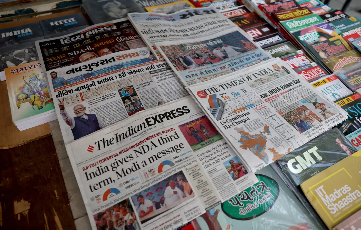 Newspapers are displayed at a roadside stall following the results of India's general election, in Ahmedabad