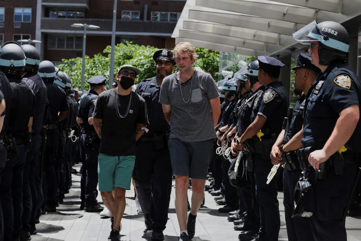 Climate control activists are led away by the NYPD after being detained outside the global headquarters of Citigroup in New York City