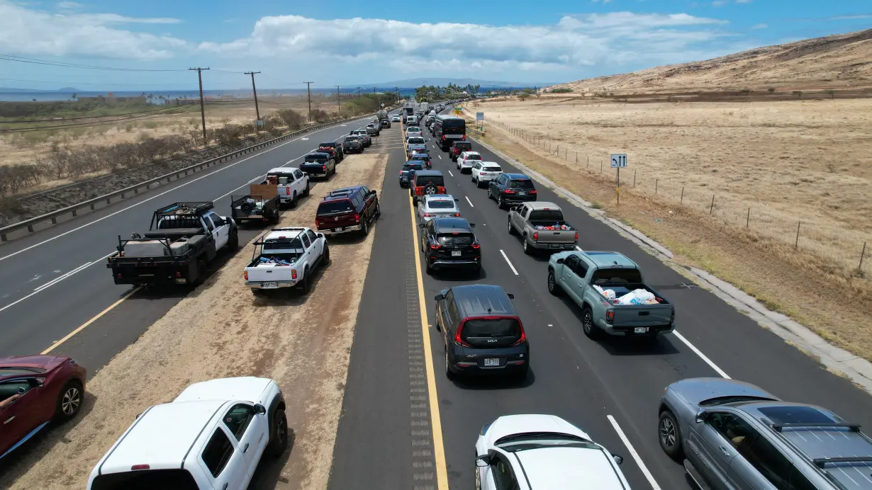 Cars are seen in traffic as residents and tourist wait on Honoapiilani Hwy to enter the town of Lahaina