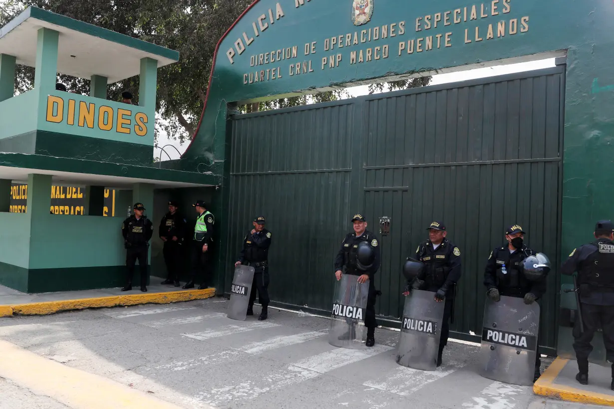 Police officers stand outside the police prison where ousted Peruvian leader Pedro Castillo is detained, in Lima